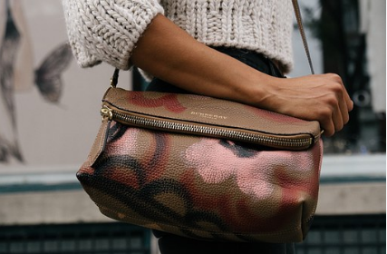 lady holding a leather bag